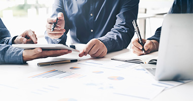 two laboratory technicians discussing data in a manufacturing facility wearing protective gear including masks gloves and lab coats showcasing modern production processes and five key safety protocols